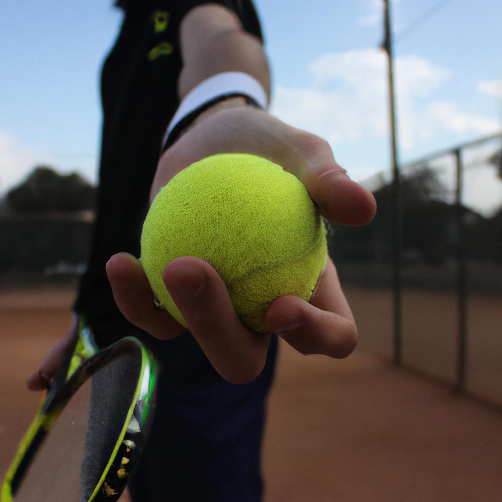 Person serving a tennis ball